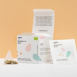 Square open package of herbal infusion Remedium Boost with single tea bag and herbs